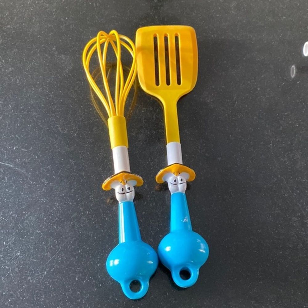 Kids cooking utensils spatula and mixer with duck faces. Plastic holes t…